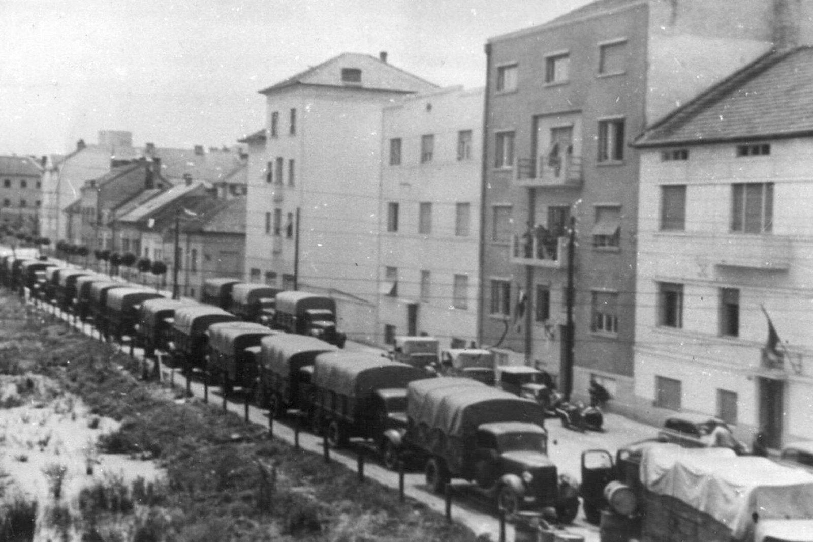 A column of army trucks along the street, Novi Sad, 1941