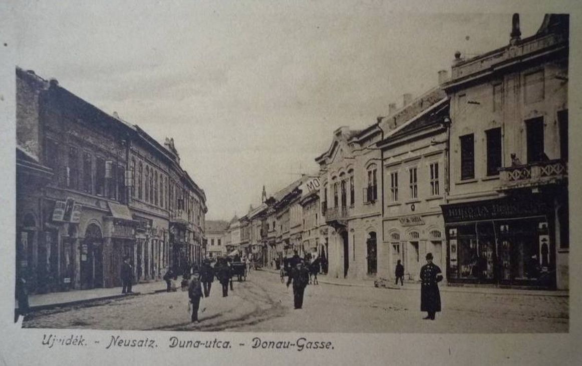 A man in a long coat walking away, Dunavska Street, Novi Sad, 1900s