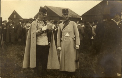 Archduke Joseph reads a document with a member of his entourage, Novi Sad Airfield, 12 May 1913