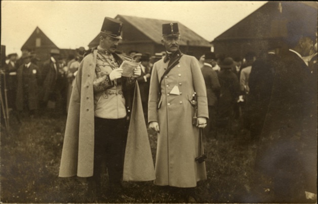 Archduke Joseph reads a document with a member of his entourage, Novi Sad Airfield, 12 May 1913